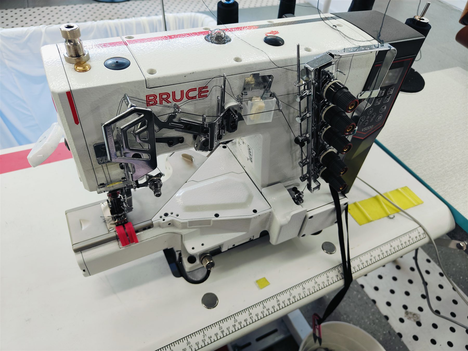 Industrial sewing machine configured for garment assembly
