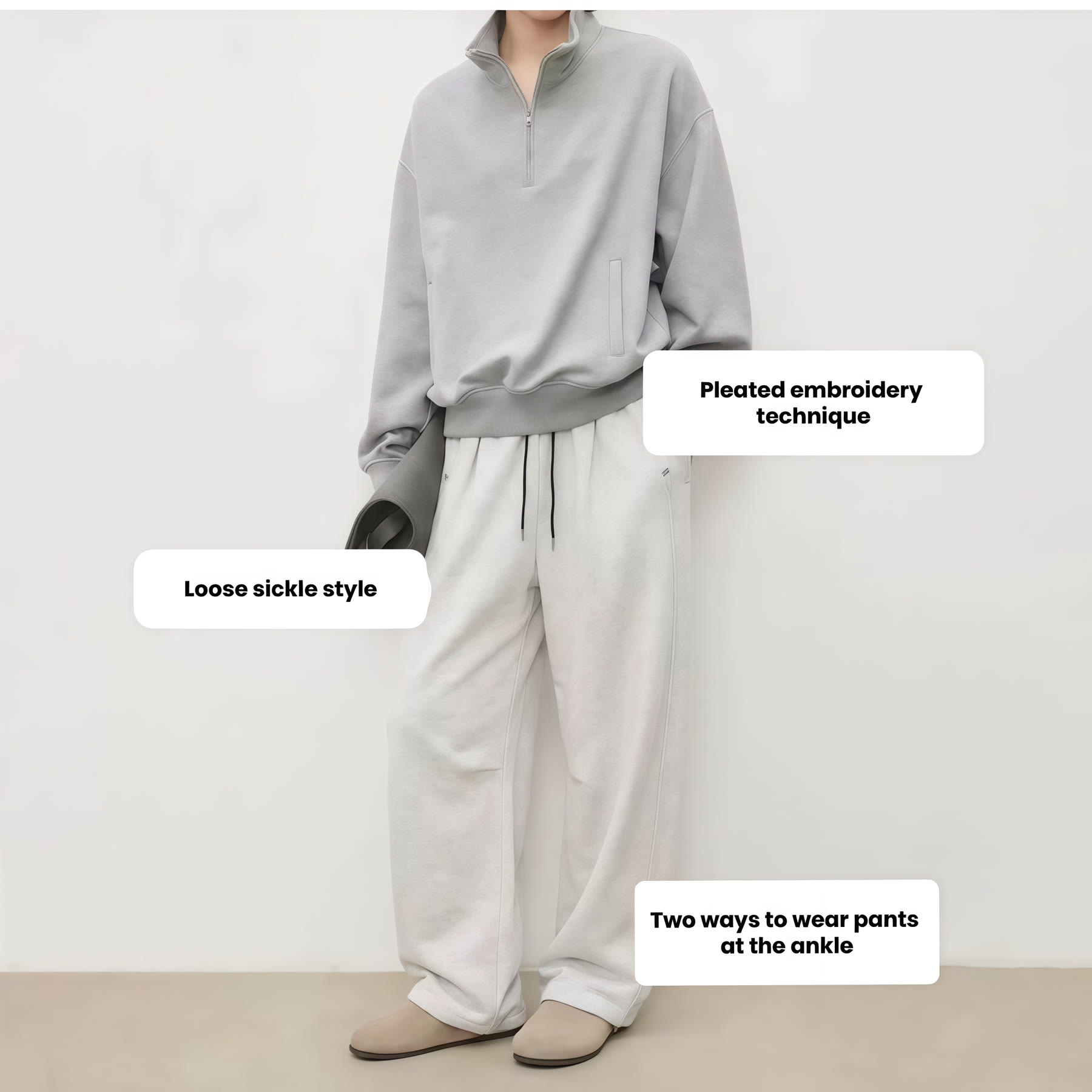 Grey zip-neck top coordinated with relaxed grey trousers